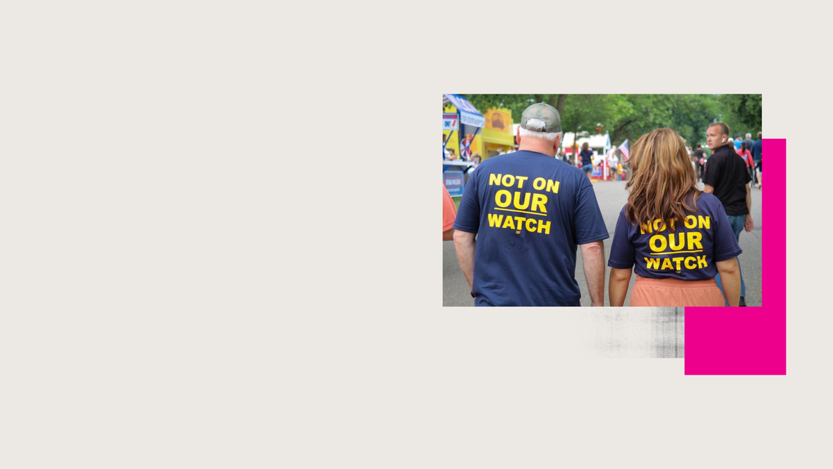 Governor Tim Walz and Lt. Governor Peggy Flanagan walking at the Minnesota State Fair with shirts that say "Not on our watch" in reference to their pledge that no abortion bans will be passed while they are in office.